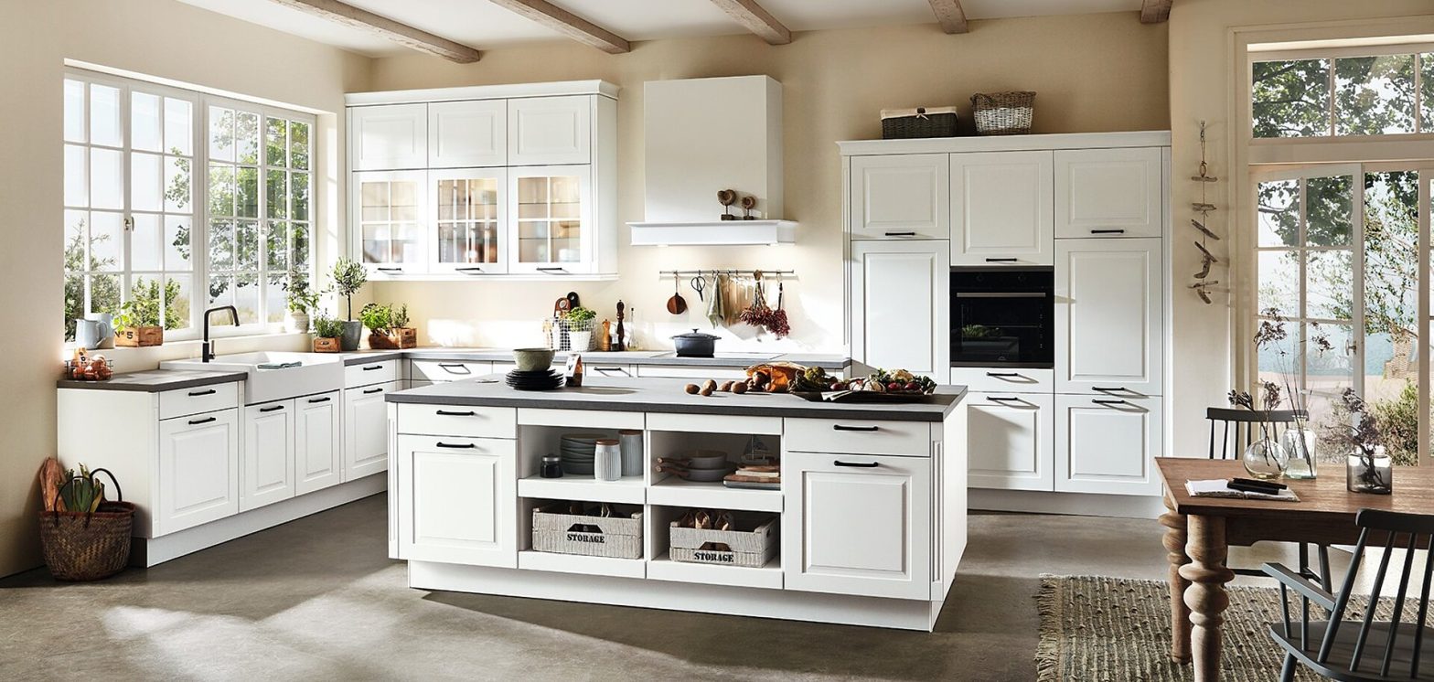 White kitchen cabinetry with wood island