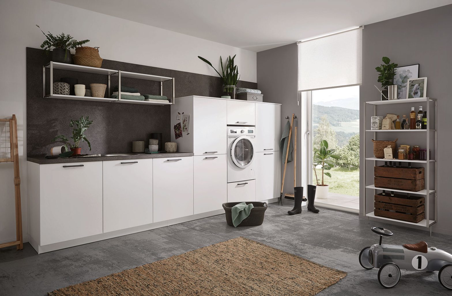 Laundry room with cabinets and storage
